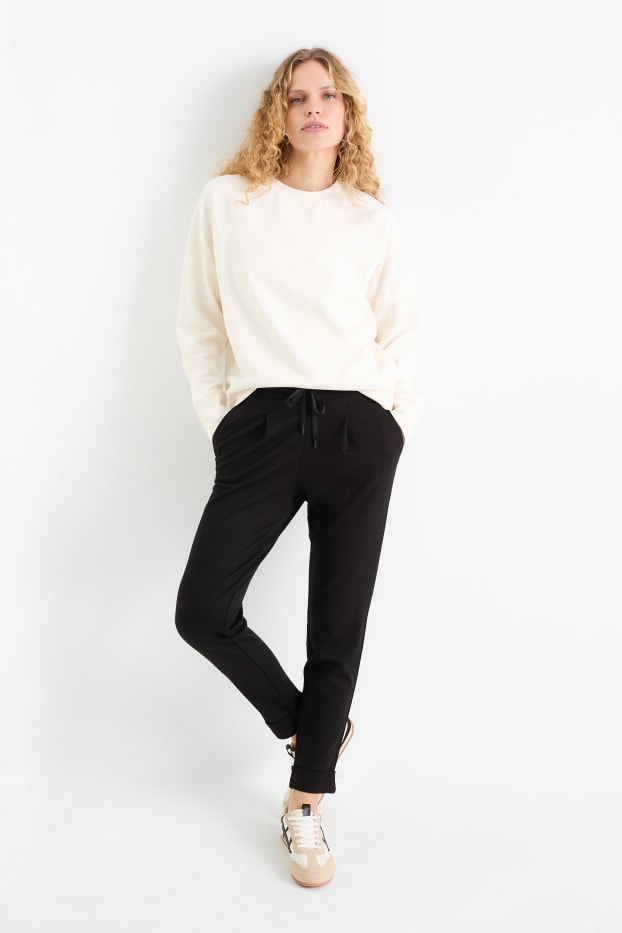 Femei - Pantaloni din jerseu - talie medie - tapered fit - negru