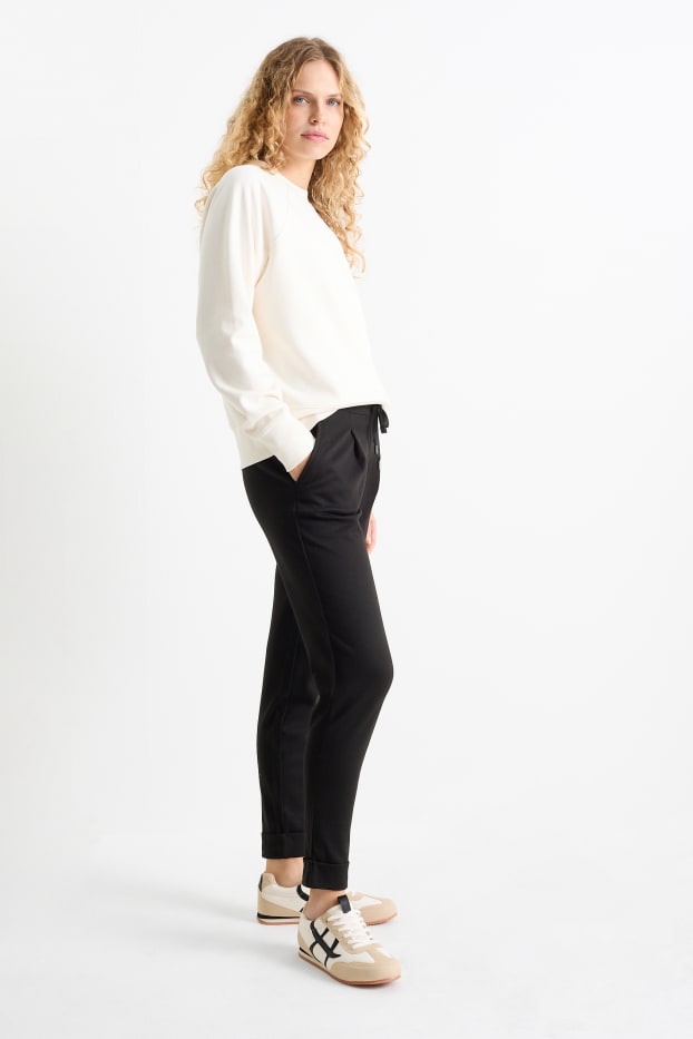 Femei - Pantaloni din jerseu - talie medie - tapered fit - negru