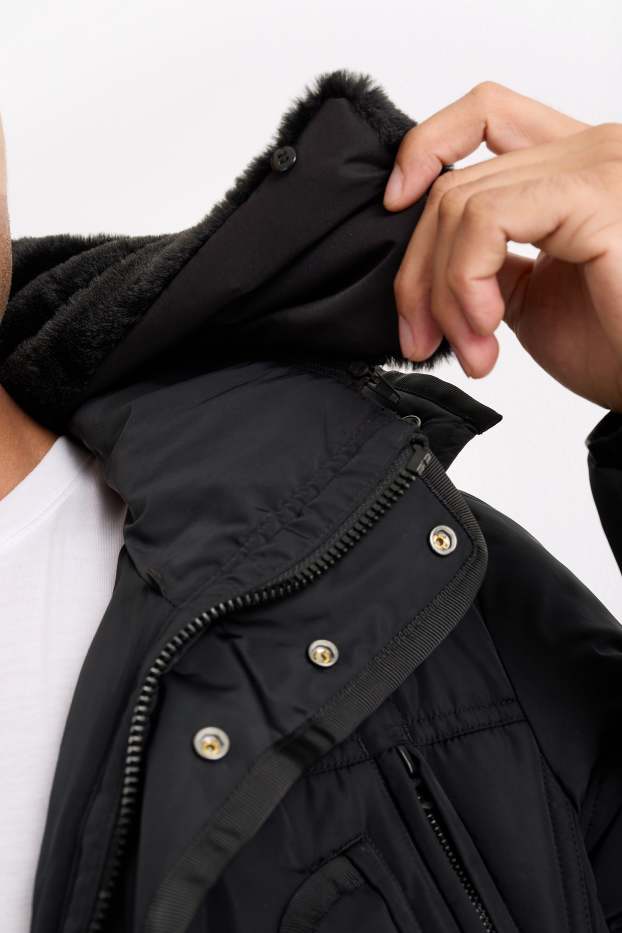Home - Jaqueta embuatada amb caputxa - impermeable - negre