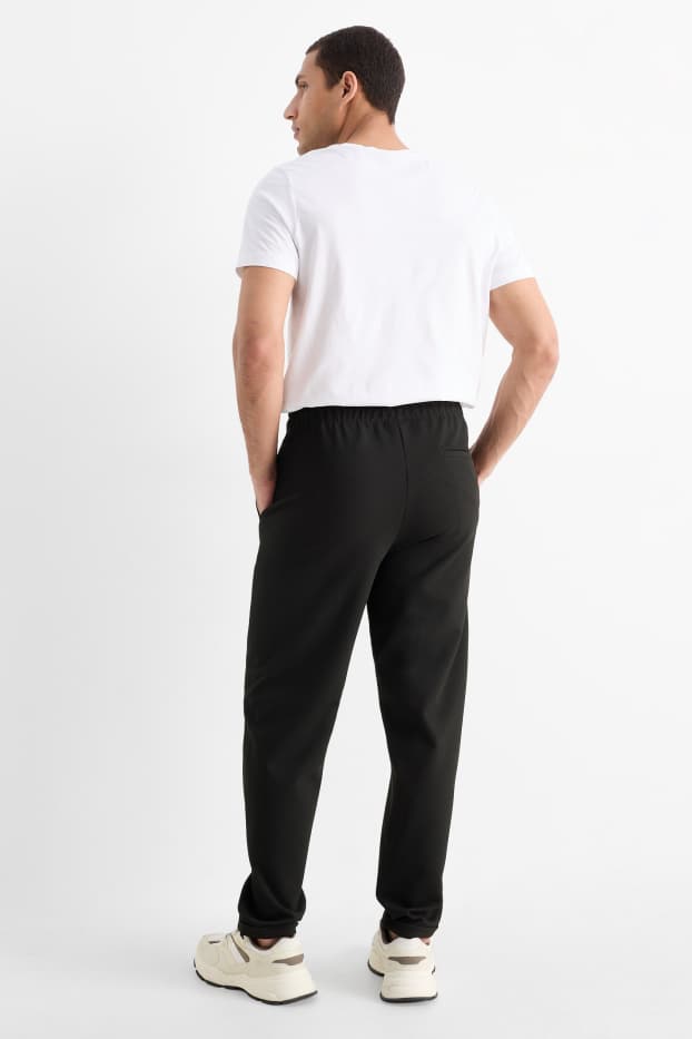 Uomo - Pantaloni sportivi - tessuto tramato - nero