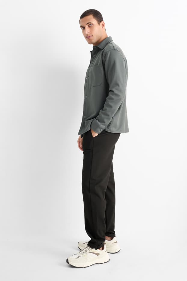 Uomo - Pantaloni sportivi - tessuto tramato - nero
