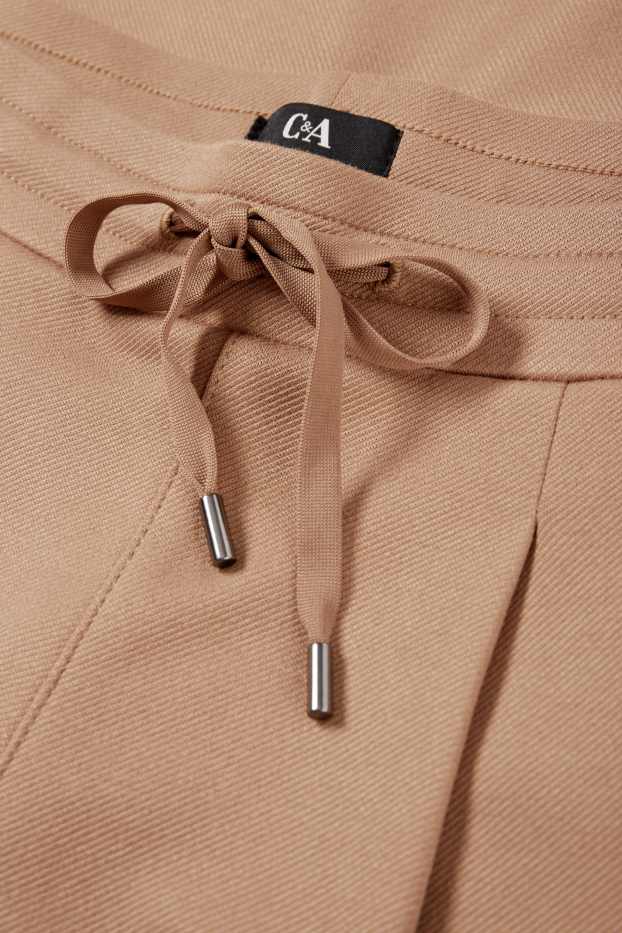 Dámské - Žerzejové kalhoty - mid waist - tapered fit - béžová