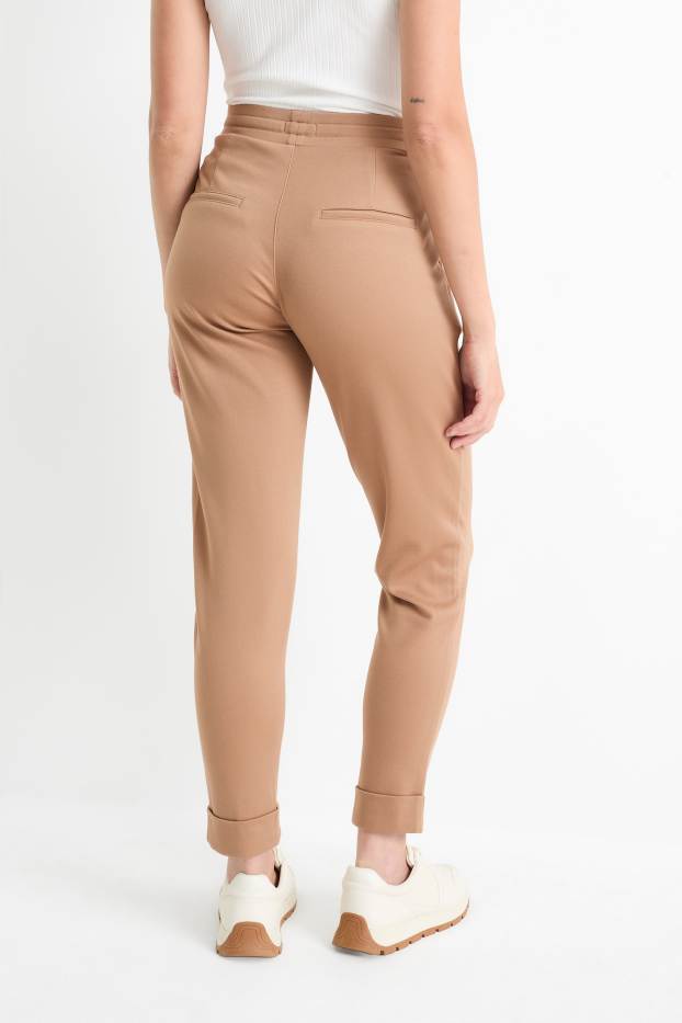 Dámské - Žerzejové kalhoty - mid waist - tapered fit - béžová