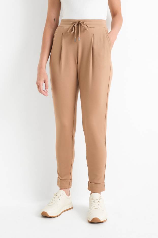 Dámské - Žerzejové kalhoty - mid waist - tapered fit - béžová