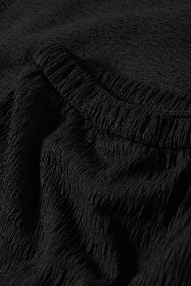 Donna - Pantaloni - vita media - flared - nero