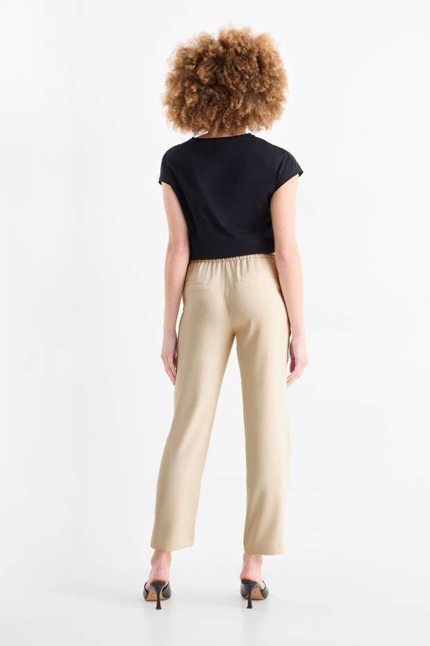 Dona - Pantalons de tela - mid waist - tapered fit - beix clar