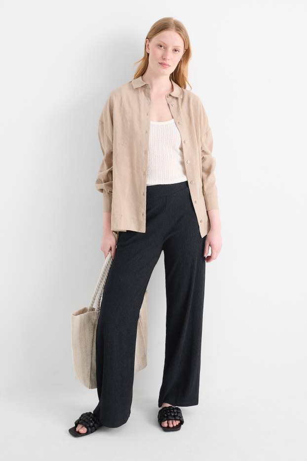Dona - Pantalons de punt - mid waist - wide leg - texturats - negre