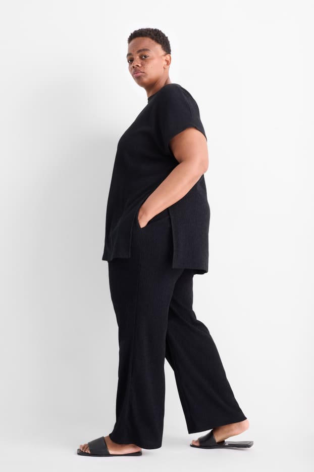 Dona - Pantalons de punt - mid waist - wide leg - texturats - negre