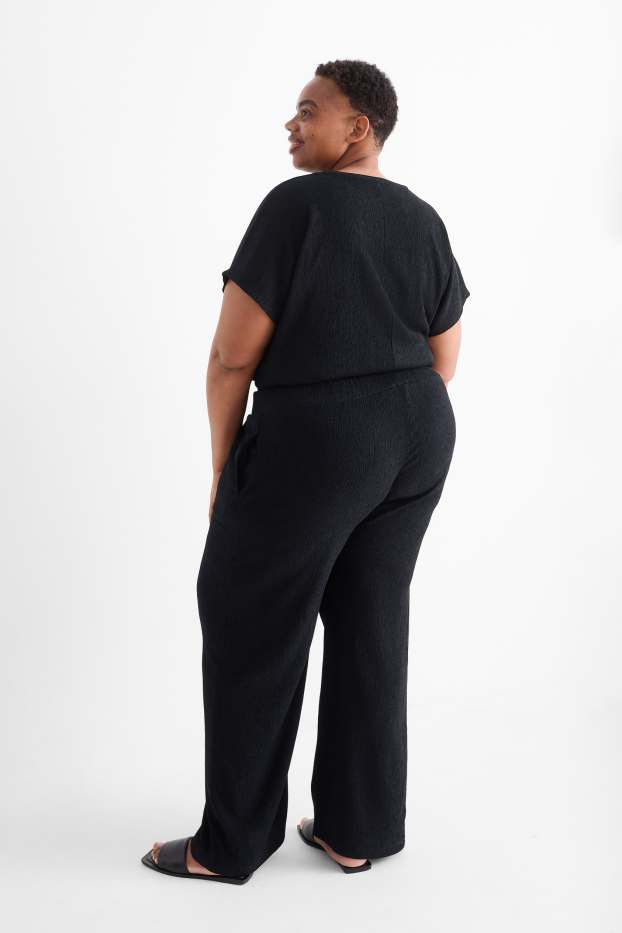 Dona - Pantalons de punt - mid waist - wide leg - texturats - negre