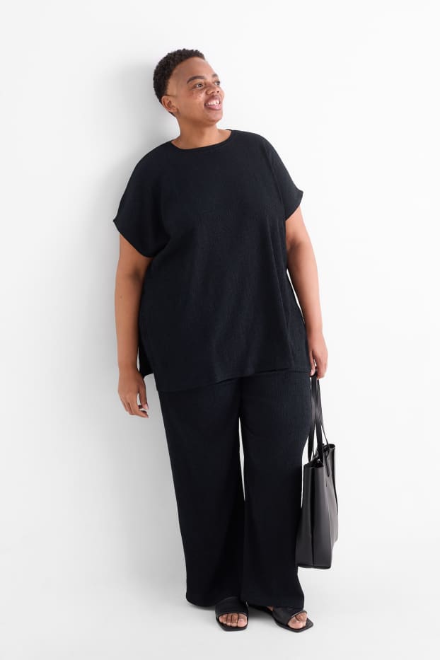 Dona - Pantalons de punt - mid waist - wide leg - texturats - negre