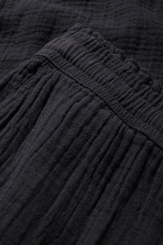 Dona - Pantalons de tela - mid waist - comfort fit - texturats - negre