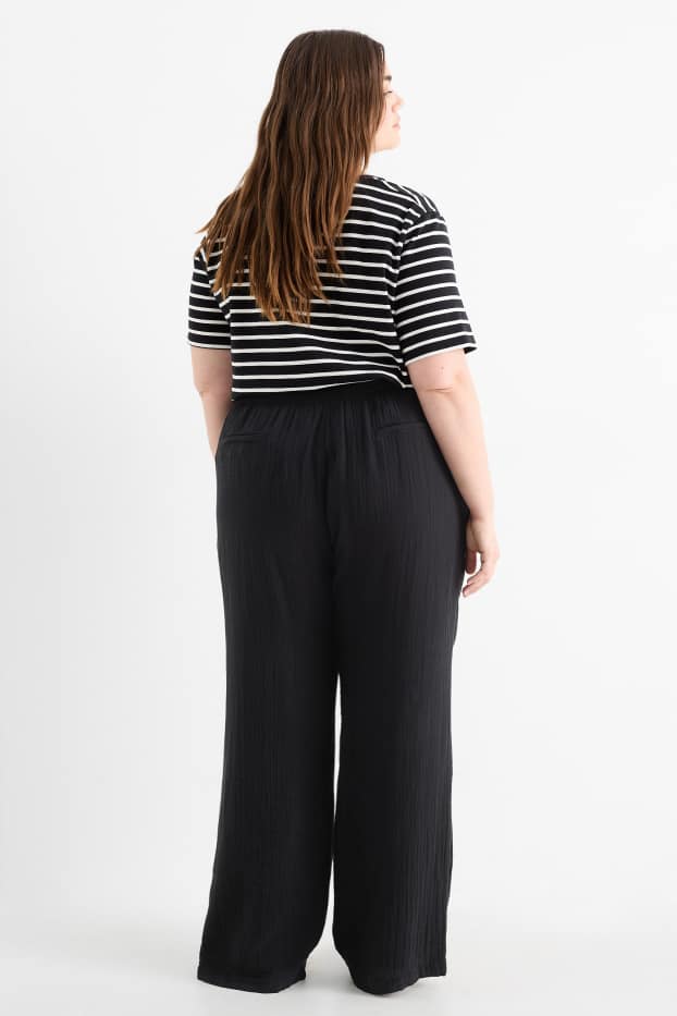 Dona - Pantalons de tela - mid waist - comfort fit - texturats - negre