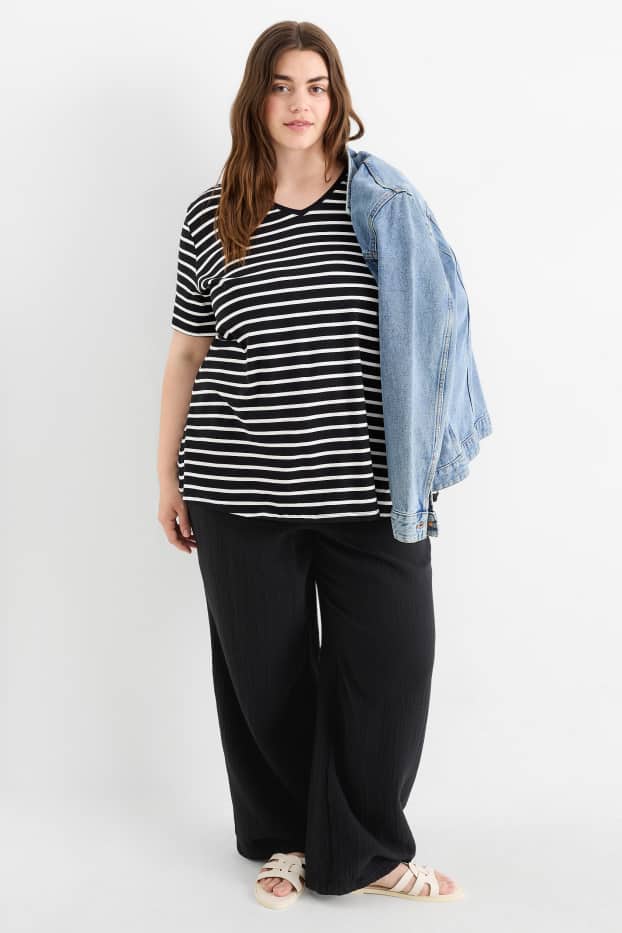 Dona - Pantalons de tela - mid waist - comfort fit - texturats - negre