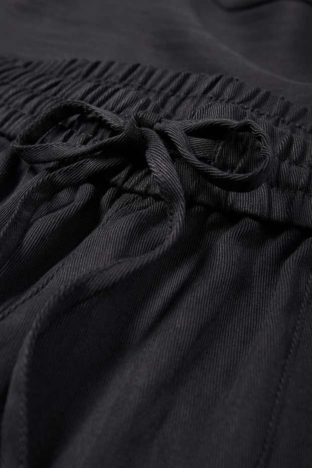 Kobiety - Spodnie materiałowe - średni stan - tapered fit - czarny