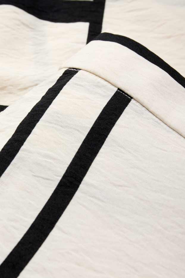 Women - Cloth trousers - high waist - wide leg - patterned - white / black