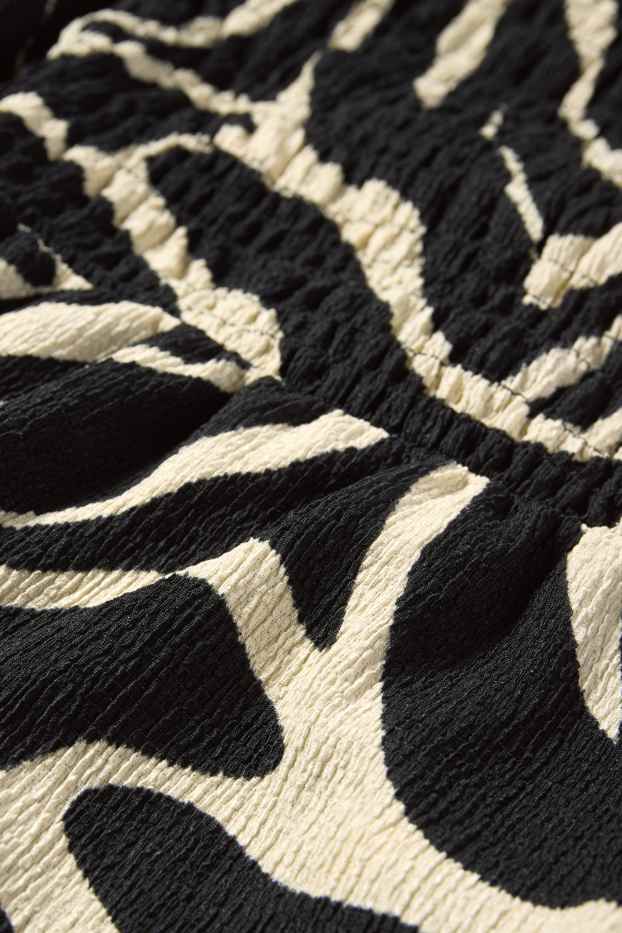 Women - Fit & flare dress - patterned - textured - smocked - black / beige