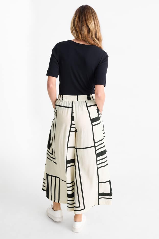 Women - Cloth trousers - high waist - wide leg - patterned - white / black