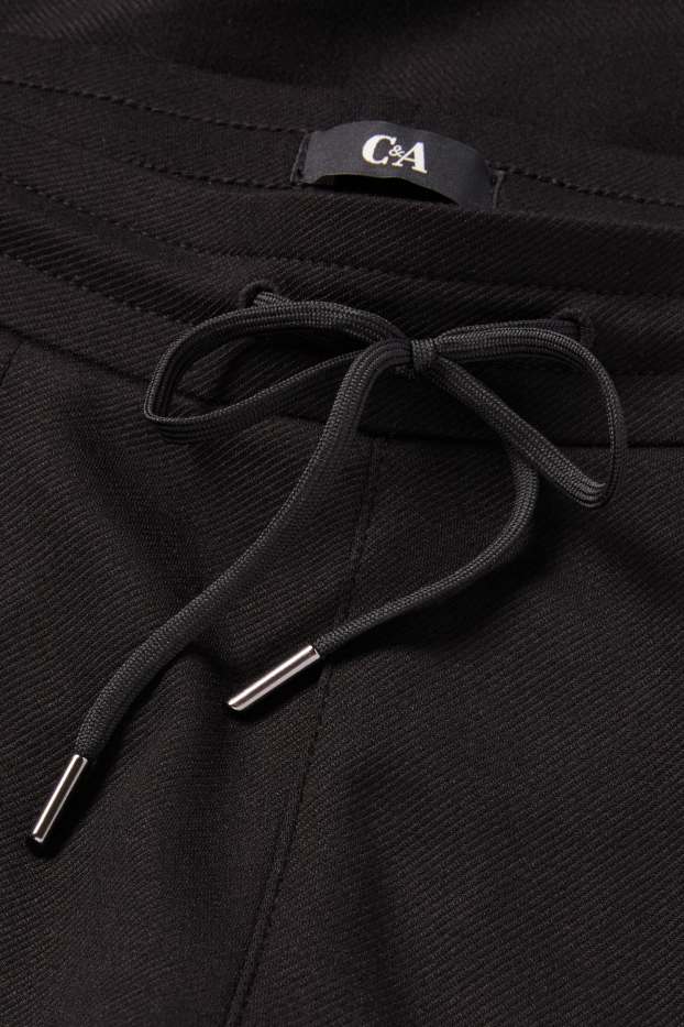 Dames - Broek van jersey - mid waist - tapered fit - zwart