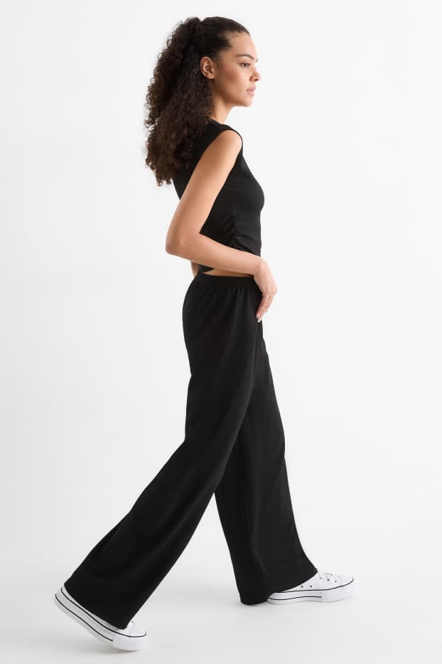 Dames - Broek van jersey - mid waist - wide leg - met structuur - zwart