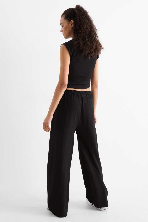 Dames - Broek van jersey - mid waist - wide leg - met structuur - zwart