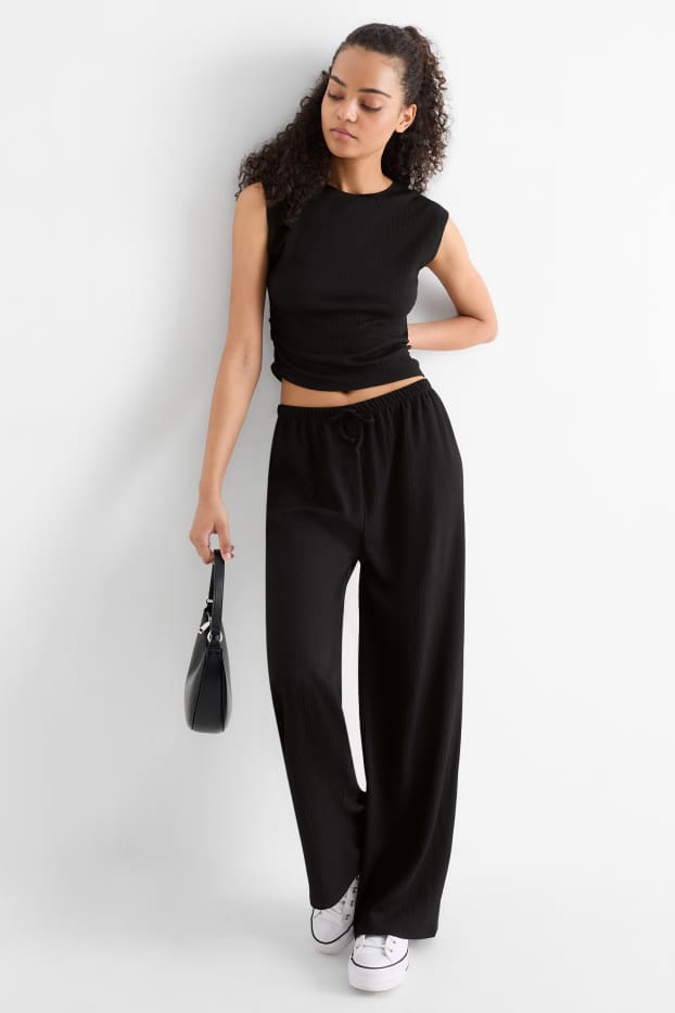 Dames - Broek van jersey - mid waist - wide leg - met structuur - zwart