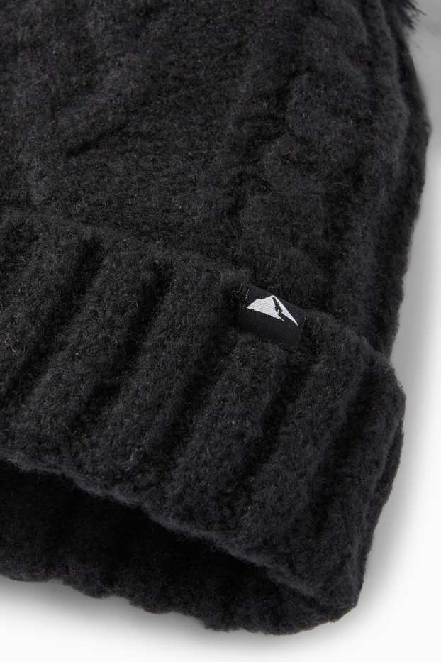 Kinderen: meisjes - Skimuts met pompon - kabelpatroon - zwart