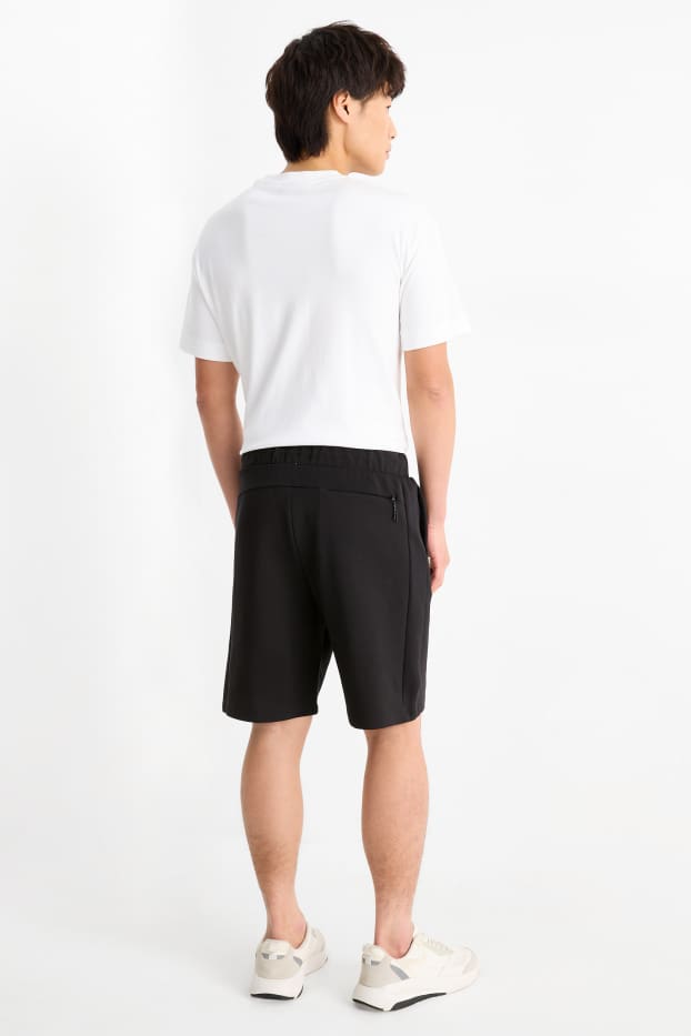 Uomo - Shorts in felpa - tessuto tramato - nero