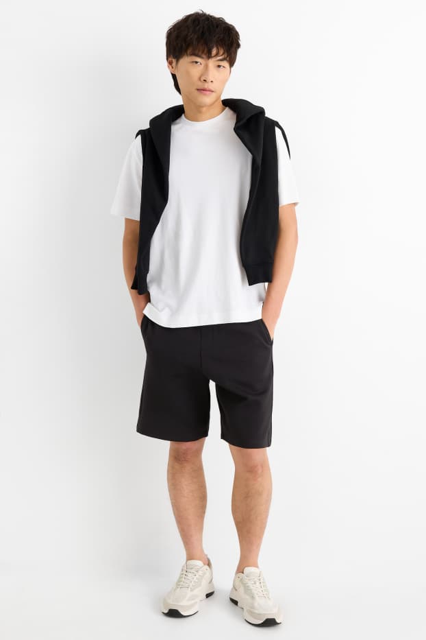 Uomo - Shorts in felpa - tessuto tramato - nero