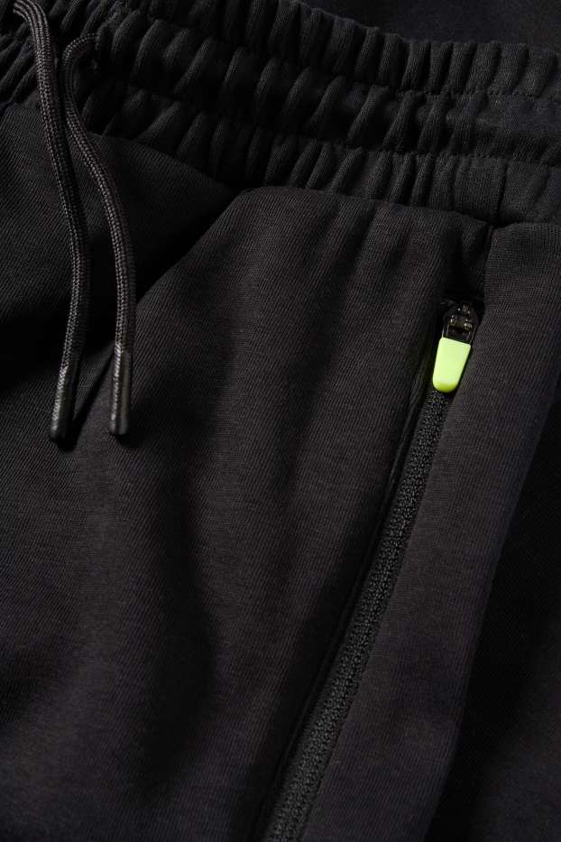Nen - Pantalons de xandall cargo - negre