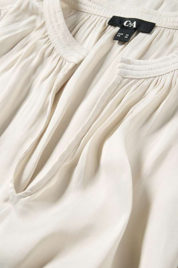 Dona - Brusa amb el coll en punta - blanc trencat