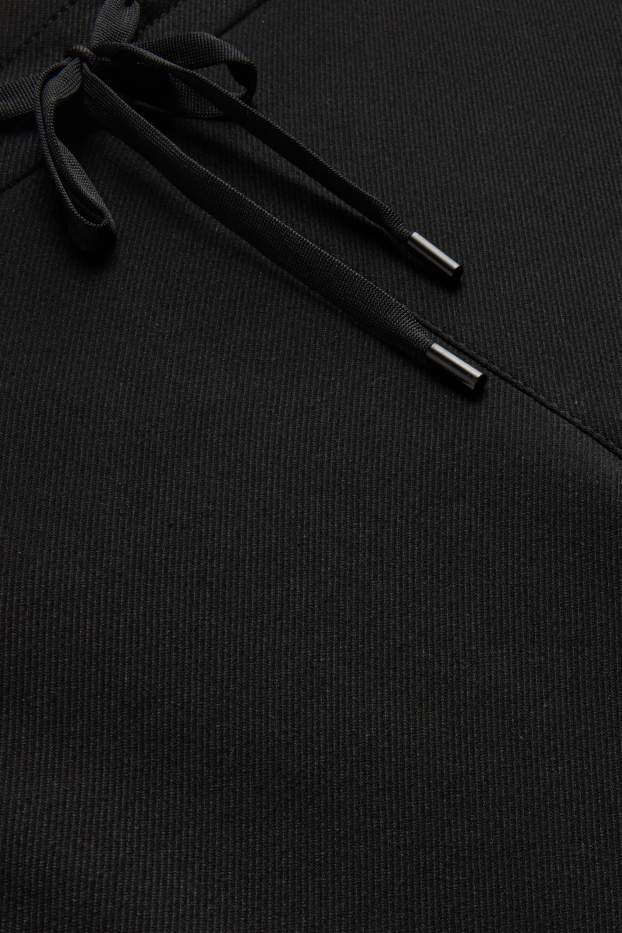 Femmes - Pantalon en toile - mid waist - tapered fit - noir