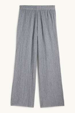 Plisowane spodnie - wysoki stan - szerokie nogawki