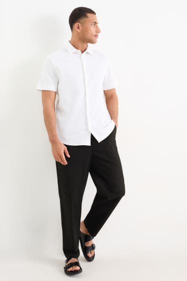 Pánské - Kalhoty chino - tapered fit - černá