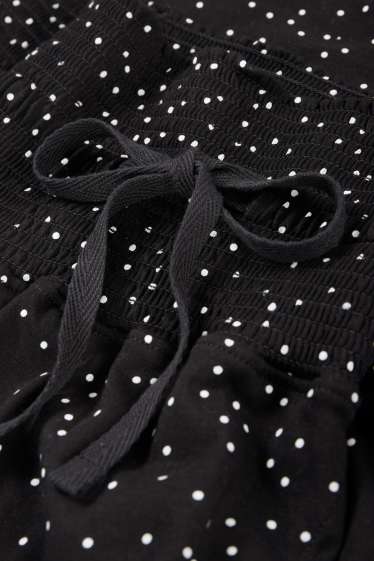 Damen - Umstands-Pyjamahose - gepunktet - schwarz