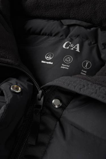 Dona - Abric embuatat amb caputxa - resistent a l’aigua - negre