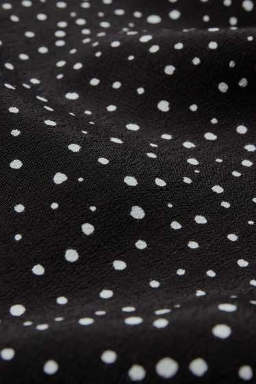 Femmes - Pantalon en toile - high waist - jambe évasée - à pois - noir