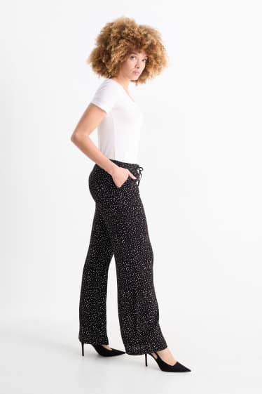 Femmes - Pantalon en toile - high waist - jambe évasée - à pois - noir