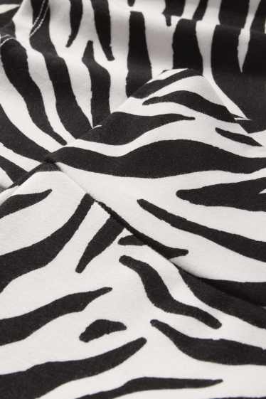 Women - Flared leggings - patterned - black / white