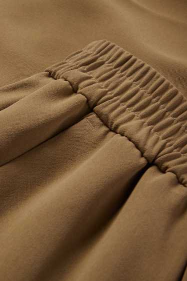 Dona - Pantalons de tela - mid waist - tapered fit - caqui