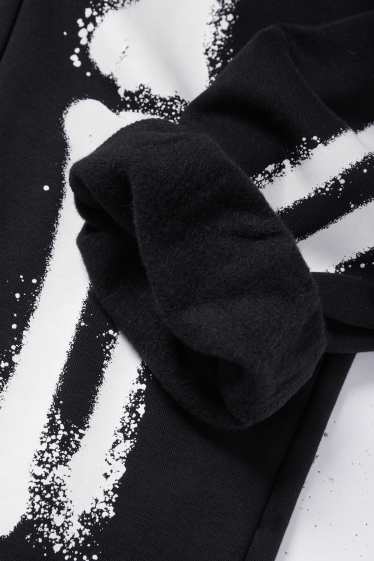 Nen - Halloween - esquelet - pantalons de xandall - brilla en la foscor - negre