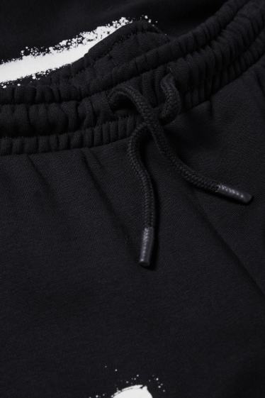 Nen - Halloween - esquelet - pantalons de xandall - brilla en la foscor - negre