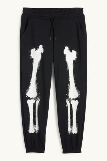 Nen - Halloween - esquelet - pantalons de xandall - brilla en la foscor - negre
