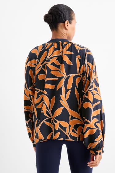 Dames - Blouse met V-hals - gebloemd - oranje / zwart