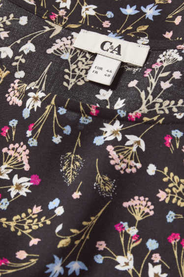 Dona - Brusa - de flors - negre