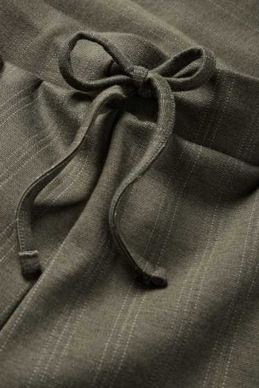 Dámské - Žerzejové kalhoty - mid waist - wide leg - s úzkými proužky - zelená