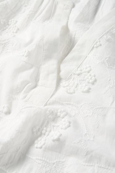 Dona - Brusa amb coll en punta - de flors - texturada - blanc