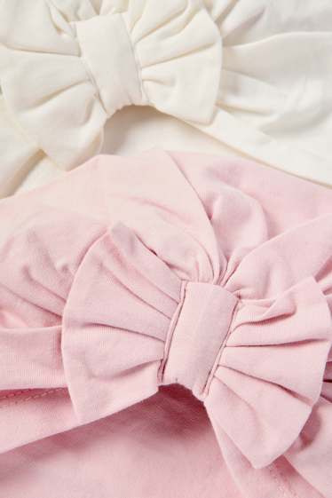 Bebeluși - fete - Multipack 2 buc. - căciulă tip turban - alb / roz