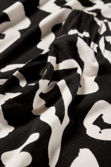 Donna - Pantaloni in jersey - vita media - straight fit - a fiori - nero / beige