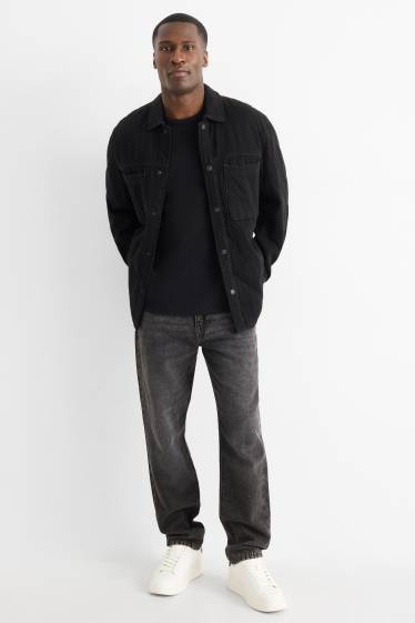 Heren - Relaxed tapered jeans, deels met linnen. - zwart