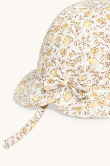 Baby: meisjes - Bloemetje en citroen - babyhoed - crèmekleurig